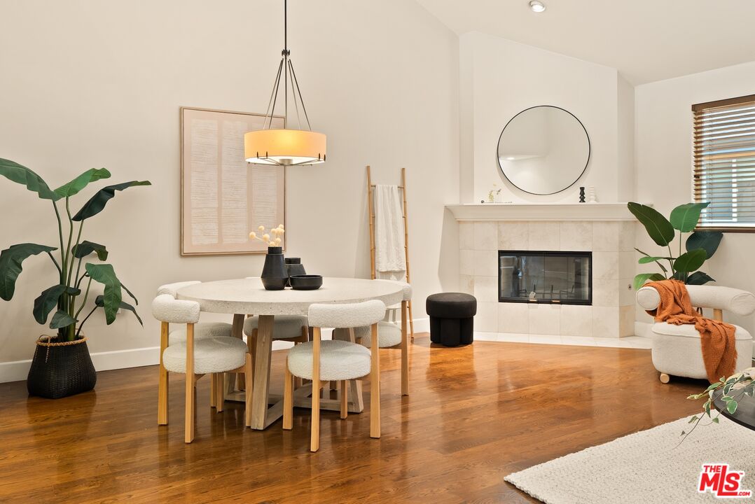 3971 Moore Street, Unit 102 Los Angeles, CA 90066 - Photo 3 of 35 a living room with furniture a fireplace and a chandelier