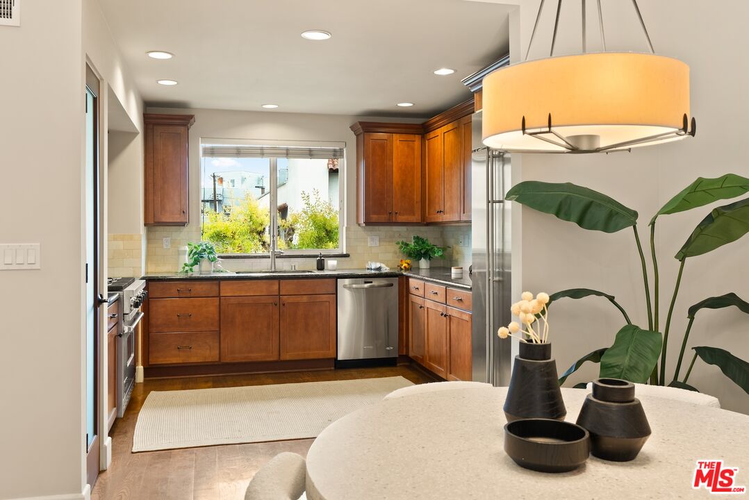 3971 Moore Street, Unit 102 Los Angeles, CA 90066 - Photo 8 of 35 a kitchen with a sink and a refrigerator