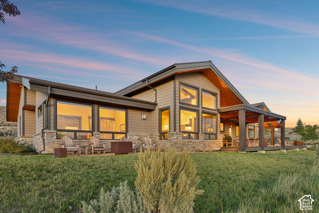 1130 Pace Road Park City, UT 84098 - Photo 73 of 73 Contemporary exterior featuring warm-toned siding, extensive window arrays, a covered outdoor patio, and stone accents