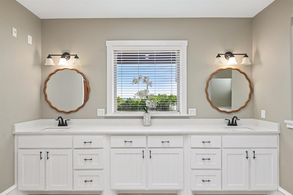2085 Switzer Road Sanger, TX 76266 - Photo 18 of 39 Dual vanity with white cabinetry, white countertops, and black fixtures