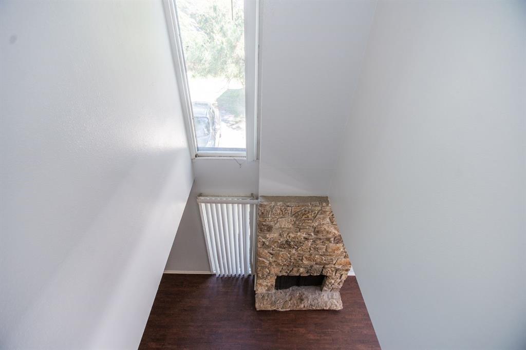 2236 Irwin Street Fort Worth, TX 76110 - Photo 5 of 9 an entryway view with wooden floor and staircase