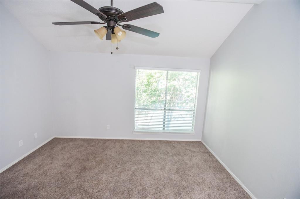 2236 Irwin Street Fort Worth, TX 76110 - Photo 6 of 9 an empty room with a window and a fan