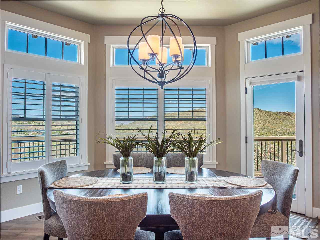 1690 Circle Stone Court Reno, NV 89523 - Photo 7 of 40 a dining room with furniture a window and a chandelier