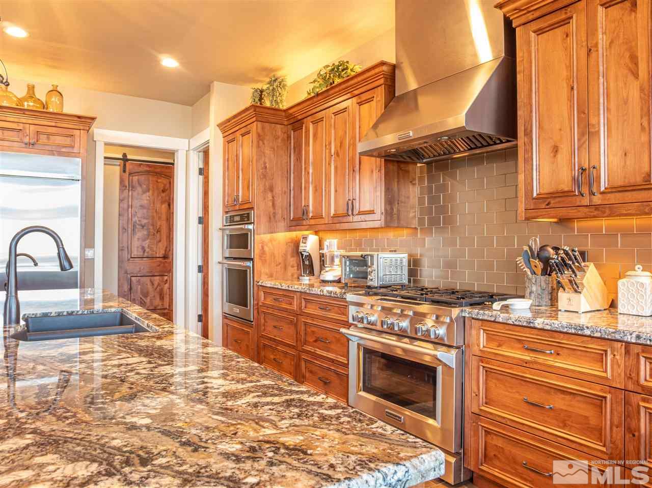 1690 Circle Stone Court Reno, NV 89523 - Photo 9 of 40 a kitchen with stainless steel appliances granite countertop a stove a sink and a refrigerator