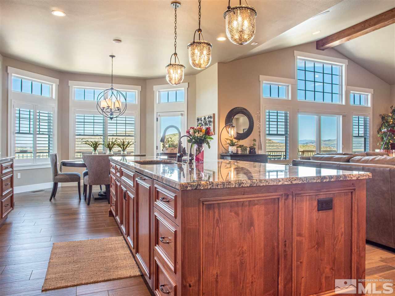 1690 Circle Stone Court Reno, NV 89523 - Photo 10 of 40 a dining hall with stainless steel appliances granite countertop a stove top oven a dining table and chairs with wooden floor