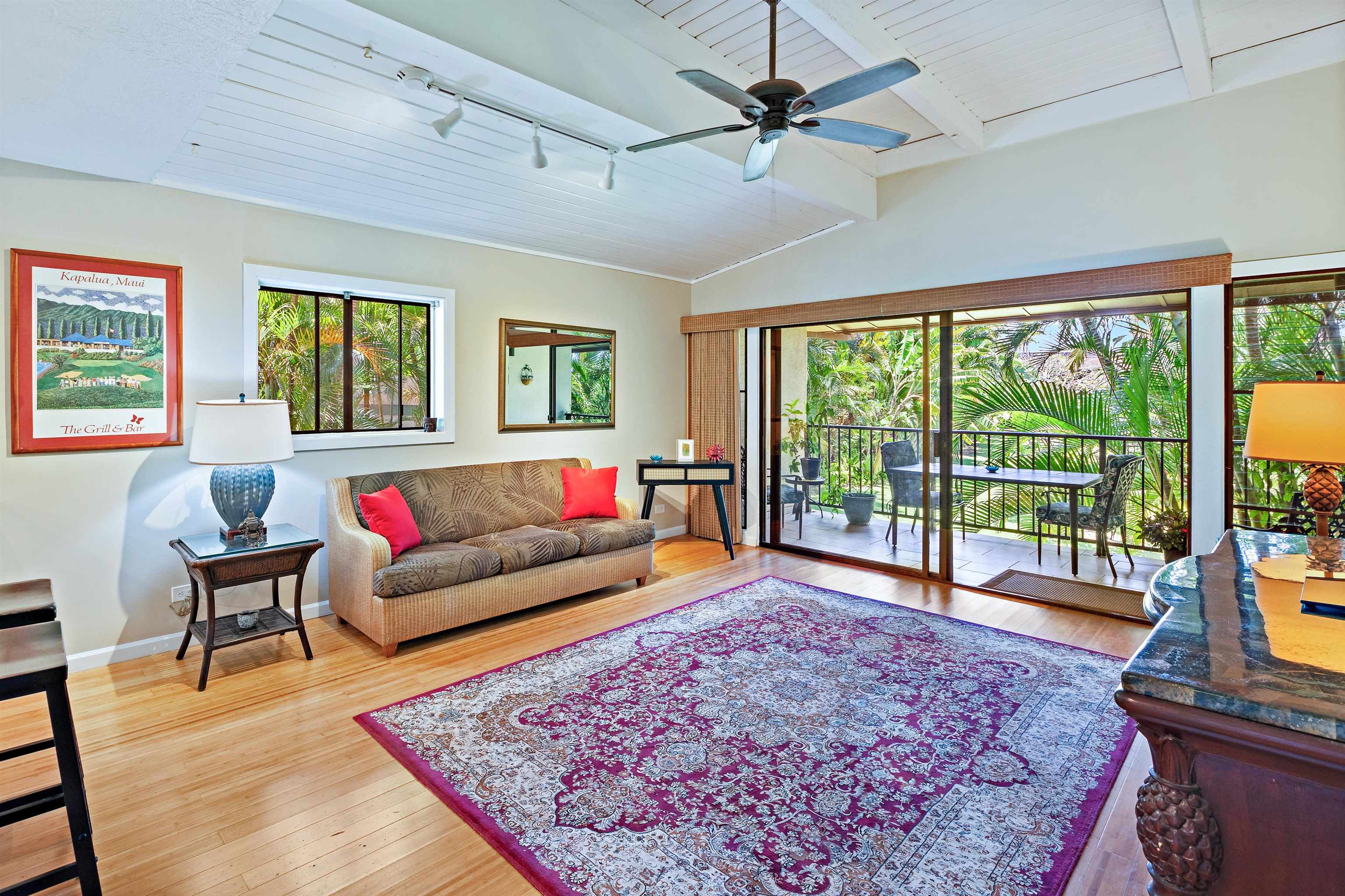 3788 Lower Honoapiilani Road, Unit D101 Lahaina, HI 96761 - Photo 2 of 40 a living room with furniture and a floor to ceiling window