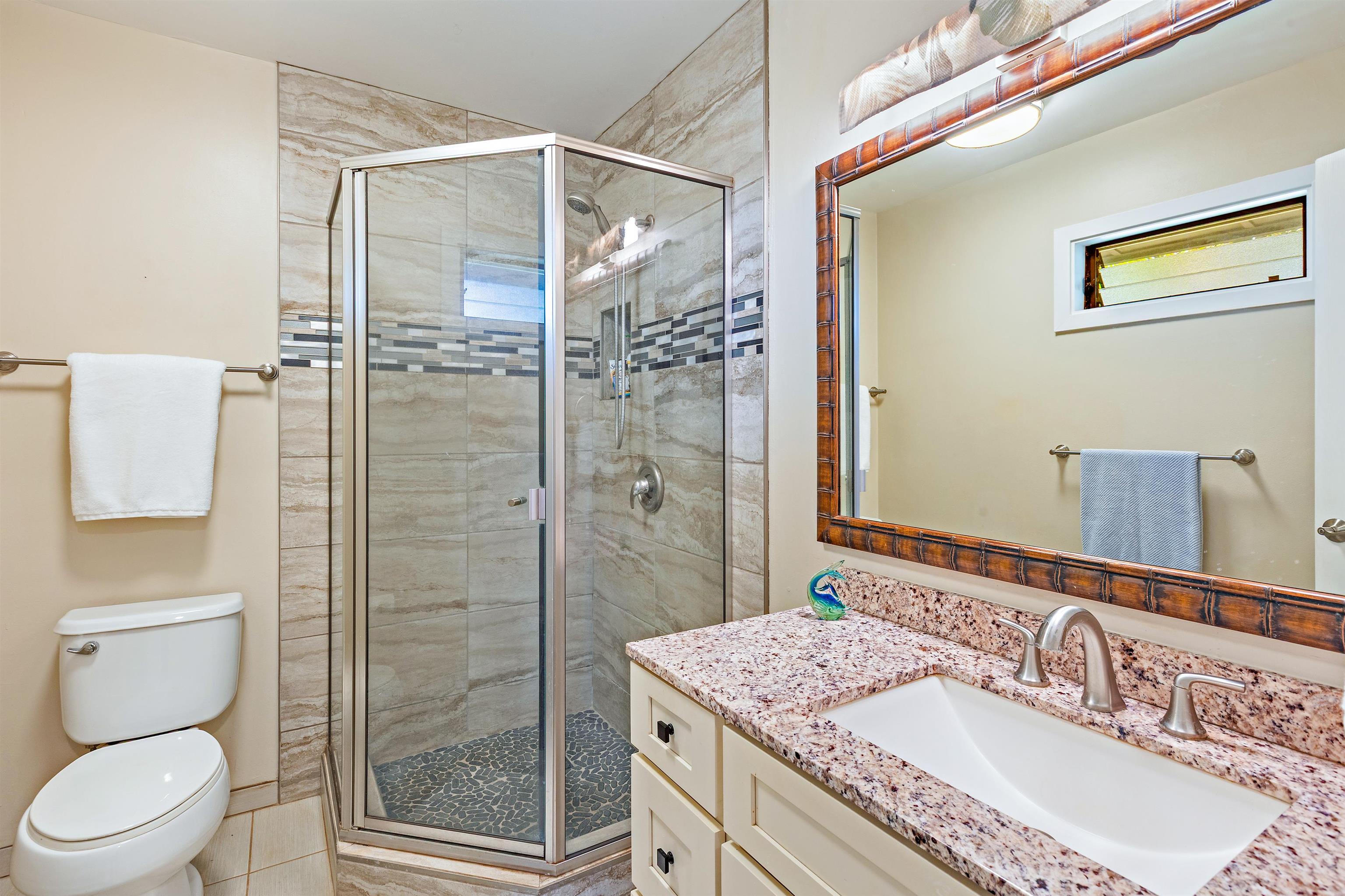 3788 Lower Honoapiilani Road, Unit D101 Lahaina, HI 96761 - Photo 25 of 40 a bathroom with a granite countertop sink toilet and shower