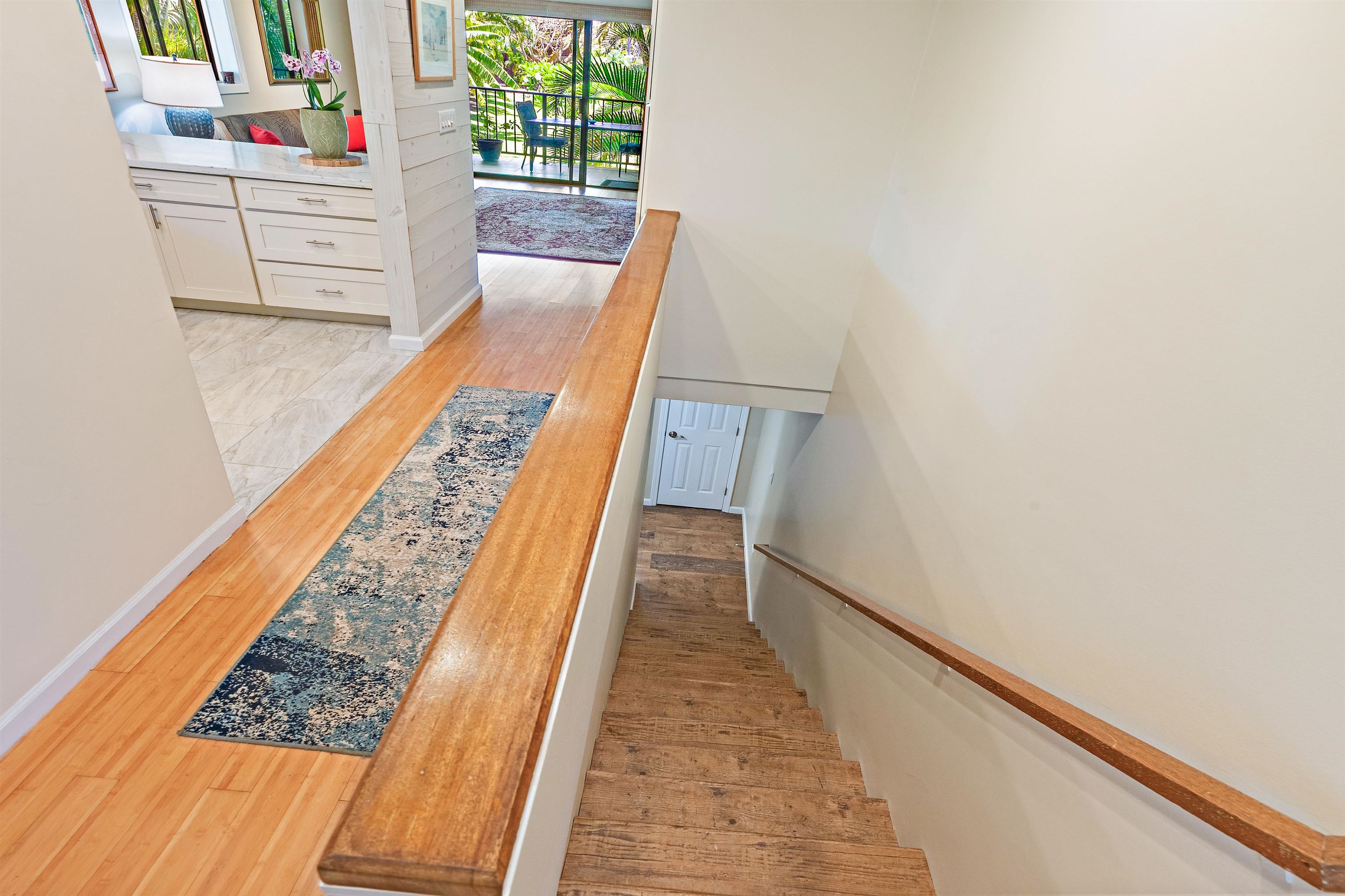 3788 Lower Honoapiilani Road, Unit D101 Lahaina, HI 96761 - Photo 26 of 40 a view of a hallway with wooden floor and stairs