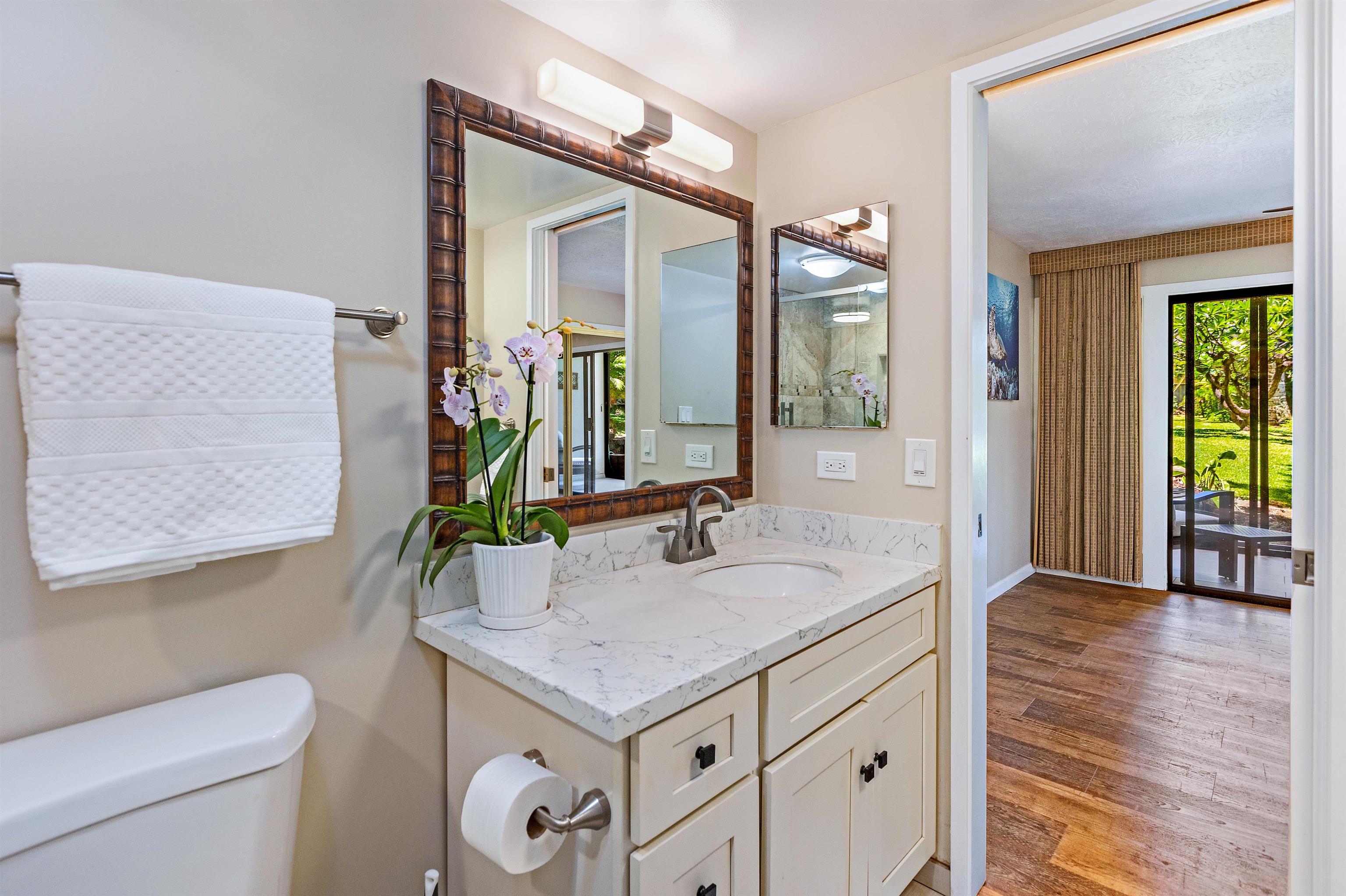 3788 Lower Honoapiilani Road, Unit D101 Lahaina, HI 96761 - Photo 31 of 40 a bathroom with a granite countertop sink and a mirror