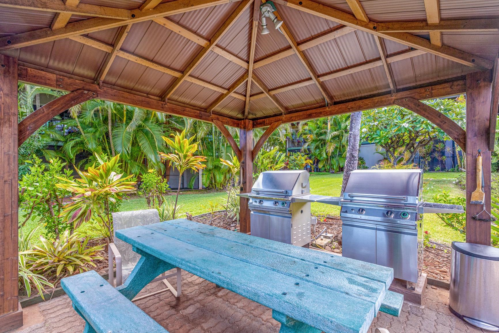 3788 Lower Honoapiilani Road, Unit D101 Lahaina, HI 96761 - Photo 37 of 40 a view of a patio with table and chairs under an umbrella