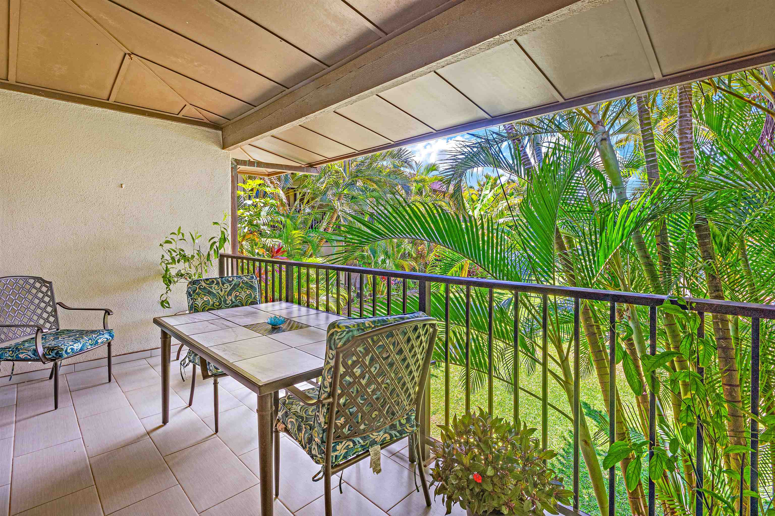 3788 Lower Honoapiilani Road, Unit D101 Lahaina, HI 96761 - Photo 8 of 40 a balcony with table and chairs and wooden floor