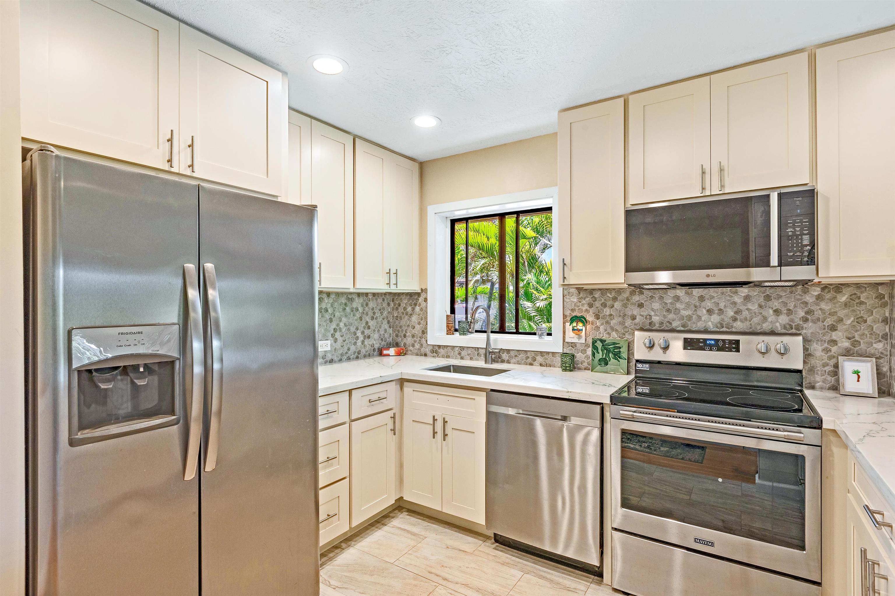 3788 Lower Honoapiilani Road, Unit D101 Lahaina, HI 96761 - Photo 10 of 40 a kitchen with a refrigerator stove and microwave