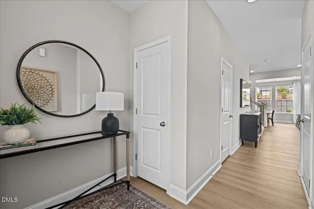 an entryway with wooden floor and staircase