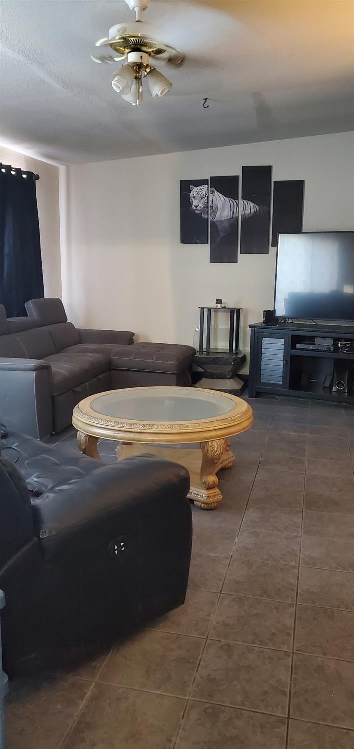 5151 Janell Way Carmichael, CA 95608 - Photo 13 of 15 a living room with furniture a flat screen tv and kitchen view