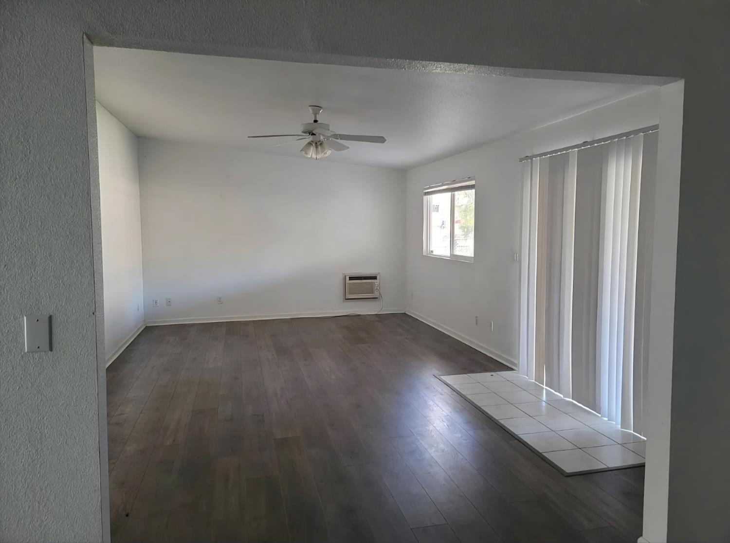 5151 Janell Way Carmichael, CA 95608 - Photo 3 of 15 an empty room with wooden floor and windows