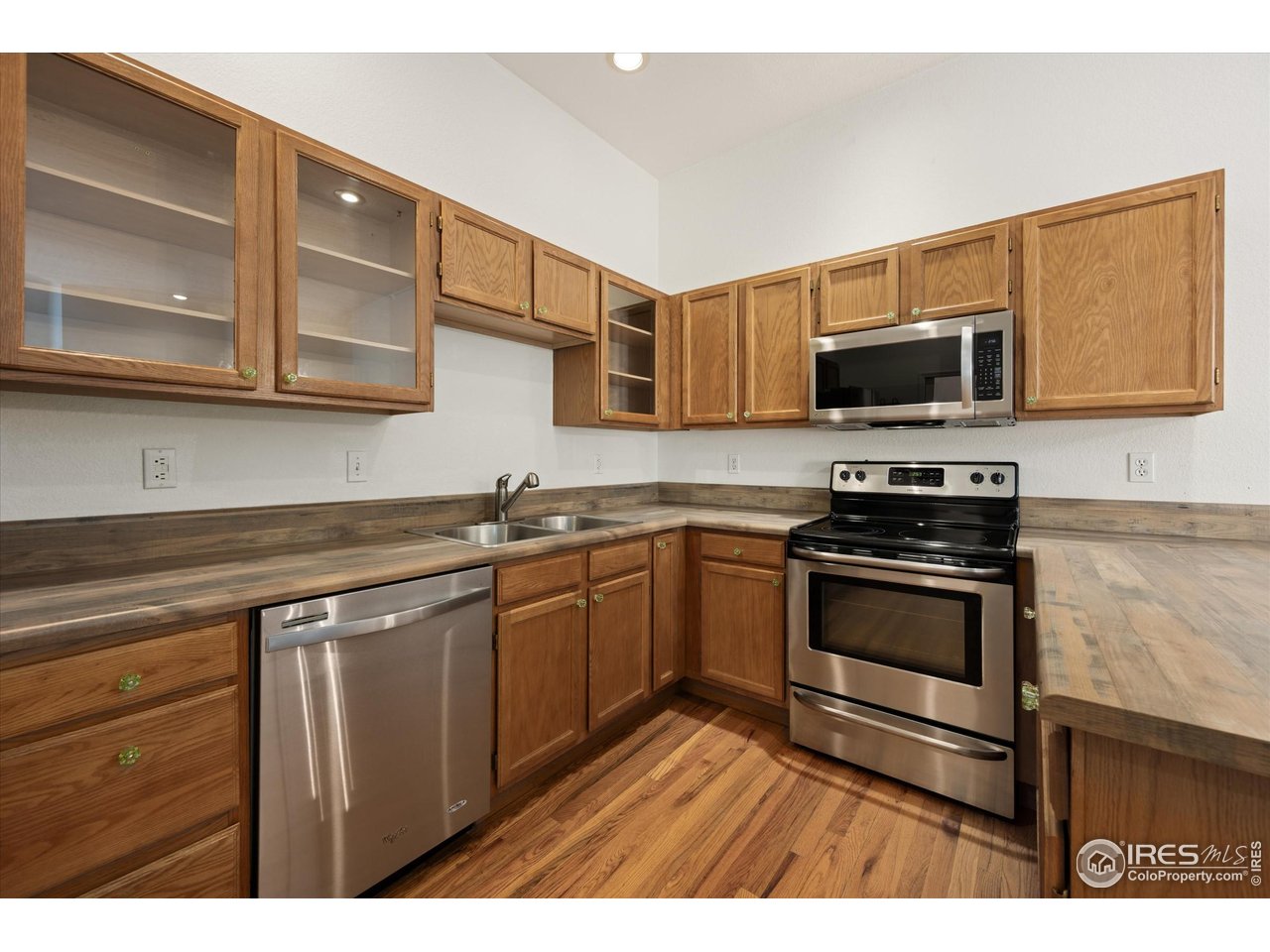 4500 Seneca Street, Unit 71 Fort Collins, CO 80526 - Photo 13 of 37 a kitchen with stainless steel appliances granite countertop a stove microwave and sink