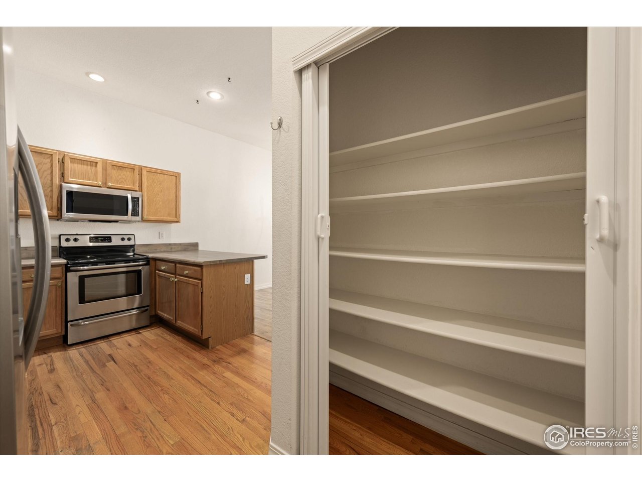 4500 Seneca Street, Unit 71 Fort Collins, CO 80526 - Photo 17 of 37 a kitchen with a refrigerator and a stove top oven