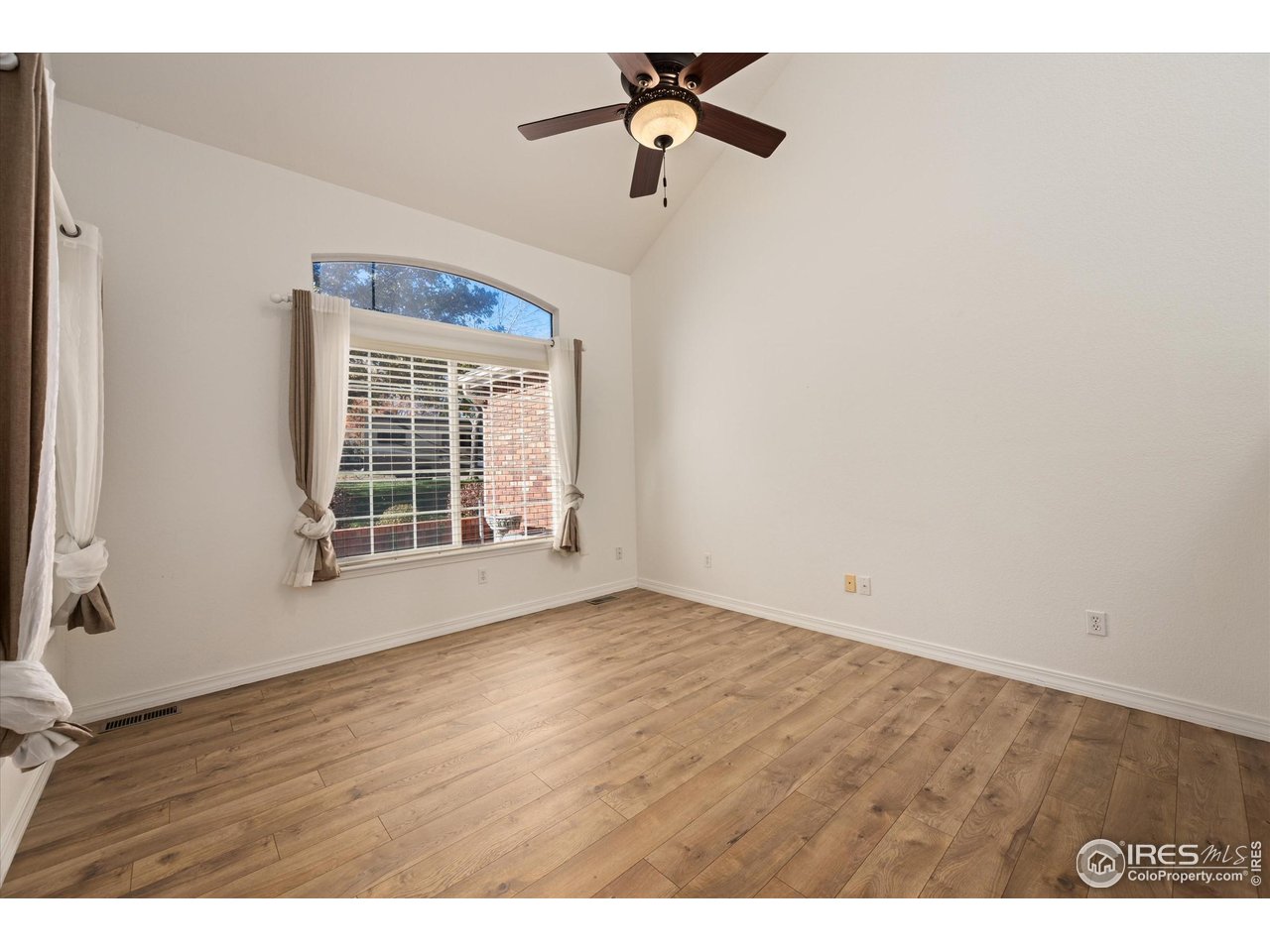 4500 Seneca Street, Unit 71 Fort Collins, CO 80526 - Photo 7 of 37 a view of an empty room with a window and wooden floor