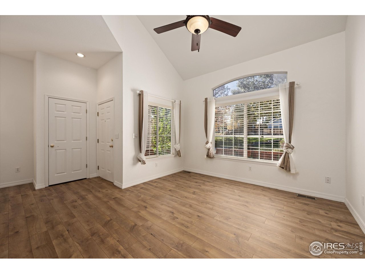 4500 Seneca Street, Unit 71 Fort Collins, CO 80526 - Photo 8 of 37 a view of an empty room with a window and wooden floor