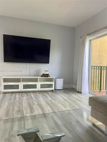 a view of room with a flat screen tv and white walls