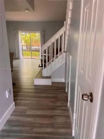 a view of entryway and hall with wooden floor