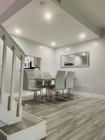 a view of kitchen with refrigerator stove and dining table