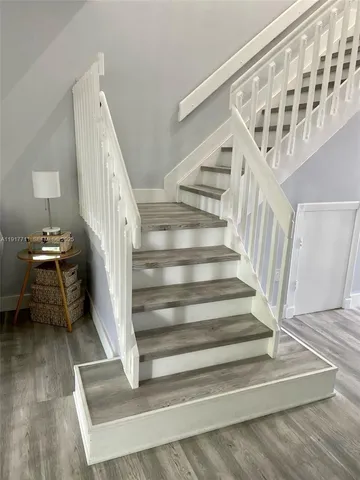 a view of entryway and hall with wooden floor