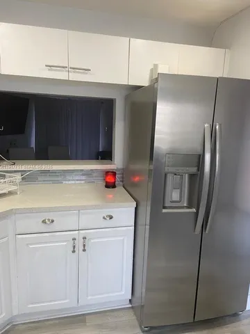a kitchen with cabinets and stainless steel appliances