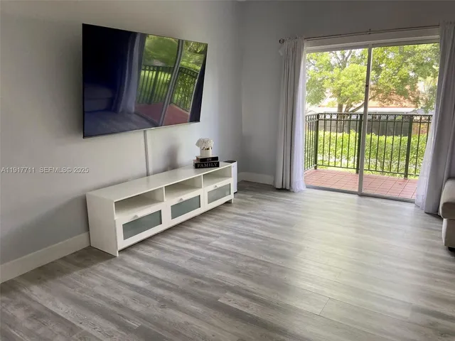 a view of a room with wooden floor and window