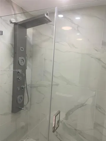 a bathroom with a shower and a mirror