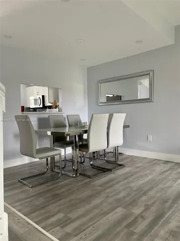 a view of a workspace with furniture and wooden floor