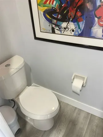 a white toilet sitting next to a small bathroom