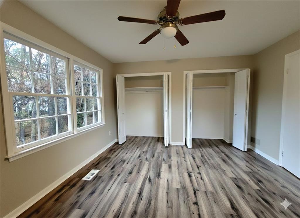 321 Tarragon Way Southwest Atlanta, GA 30331 - Photo 12 of 15 wooden floor in an empty room with a window