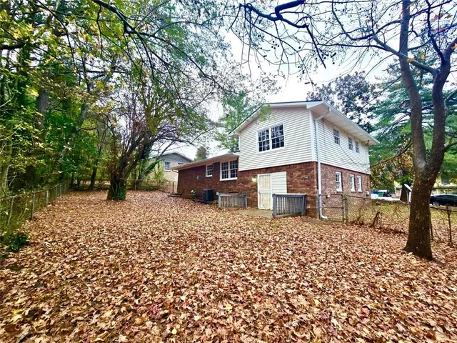 a house that has a tree in front of it