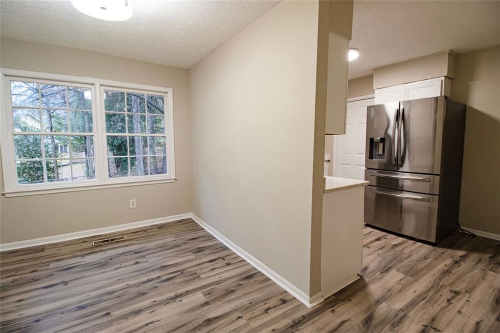 321 Tarragon Way Southwest Atlanta, GA 30331 - Photo 4 of 15 a view of a kitchen with wooden floor and electronic appliances