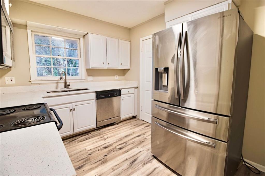 321 Tarragon Way Southwest Atlanta, GA 30331 - Photo 6 of 15 a kitchen with a refrigerator a sink and a stove top oven