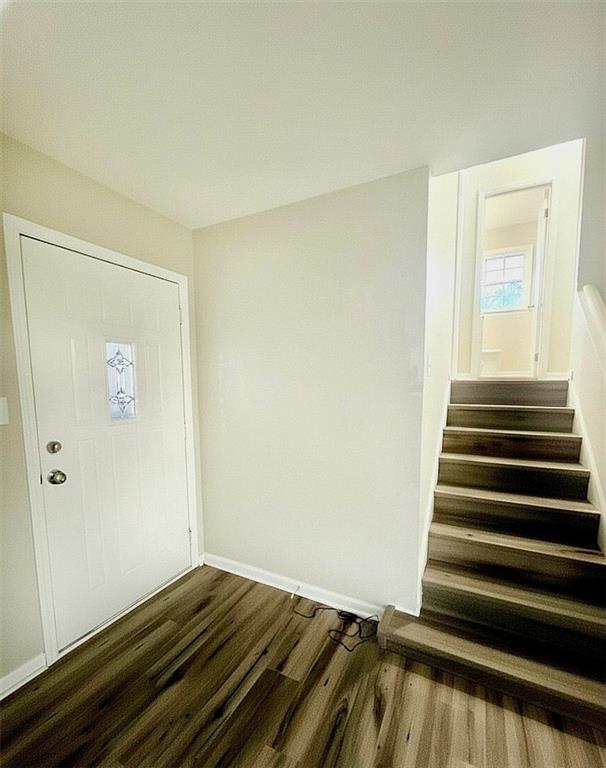 321 Tarragon Way Southwest Atlanta, GA 30331 - Photo 7 of 15 a view of a room with wooden floor and white walls