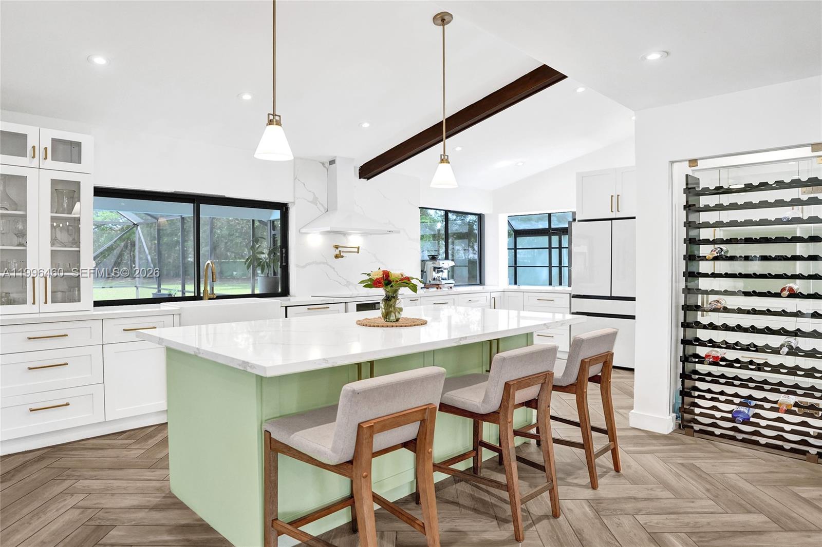 18428 102nd Way South Boca Raton, FL 33498 - Photo 27 of 70 a kitchen with stainless steel appliances kitchen island granite countertop a table chairs and a view of living room