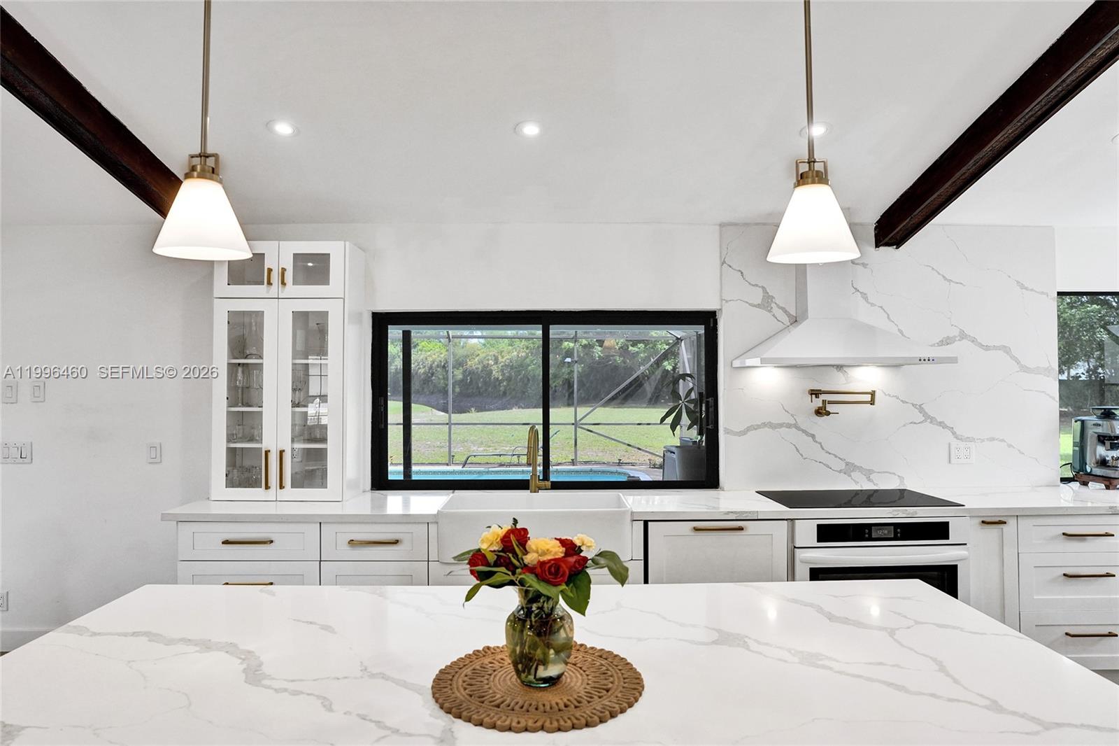 18428 102nd Way South Boca Raton, FL 33498 - Photo 29 of 70 a kitchen with stainless steel appliances kitchen island a large counter space a sink and a window