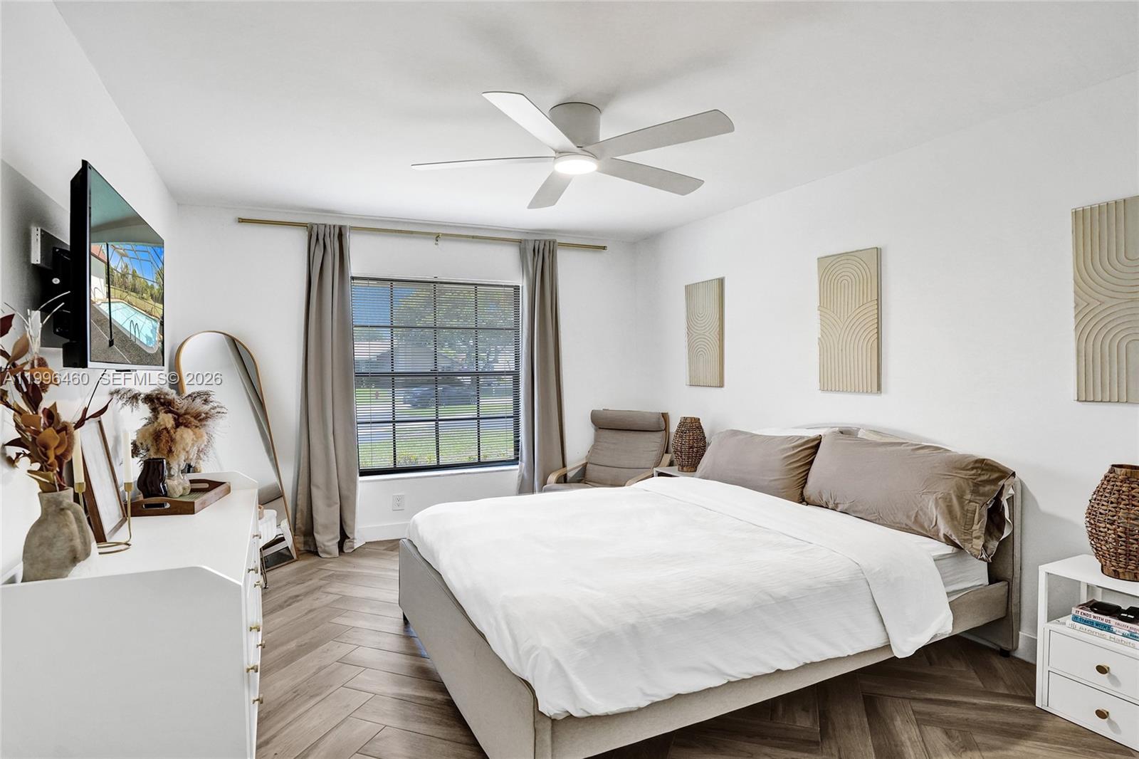 18428 102nd Way South Boca Raton, FL 33498 - Photo 42 of 70 a bedroom with a bed a flat screen tv and a large window