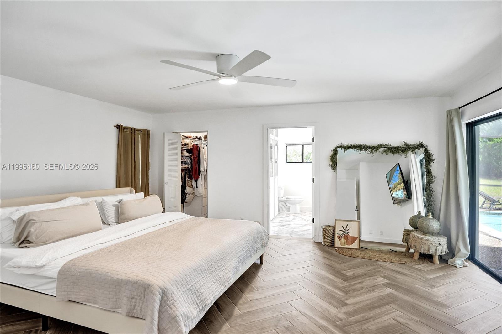 18428 102nd Way South Boca Raton, FL 33498 - Photo 50 of 70 a bedroom with a bed and a mirror