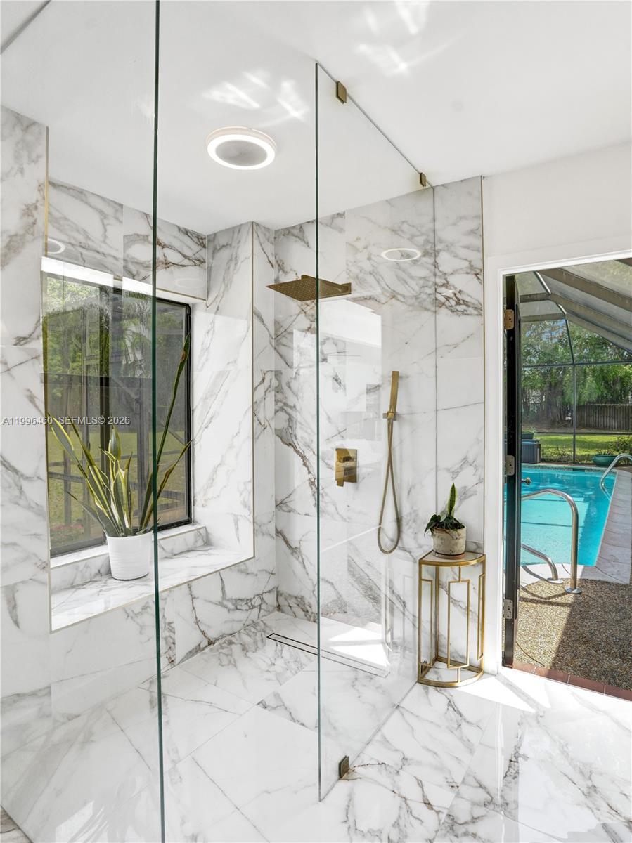 18428 102nd Way South Boca Raton, FL 33498 - Photo 54 of 70 a living room with a floor to ceiling window and a glass door
