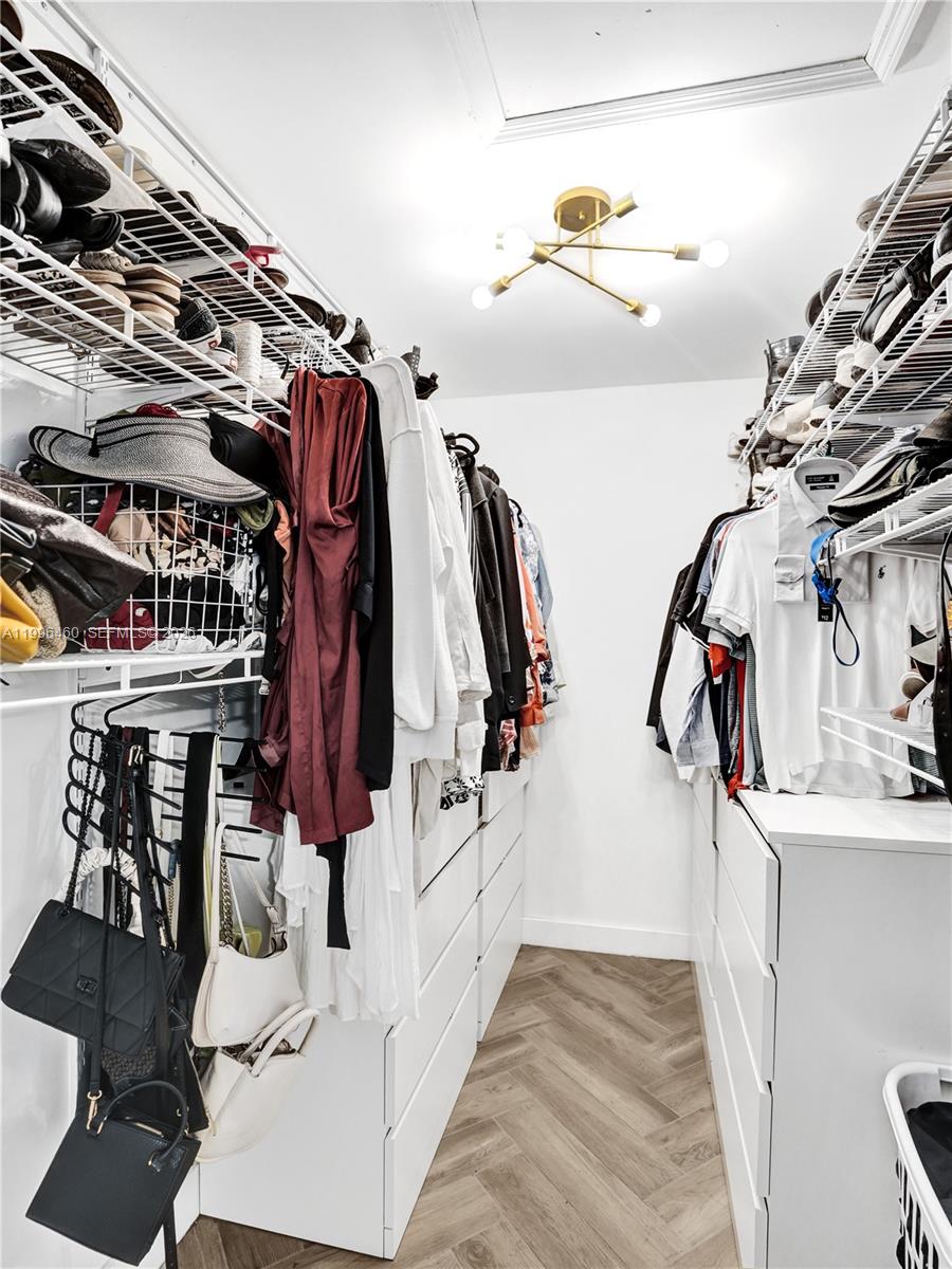 18428 102nd Way South Boca Raton, FL 33498 - Photo 56 of 70 a view of walk in closet with clothes and shoes