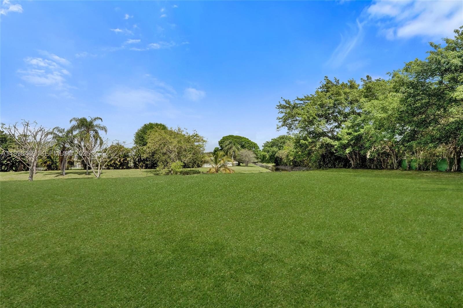 18428 102nd Way South Boca Raton, FL 33498 - Photo 65 of 70 a front view of a house with lots of green space