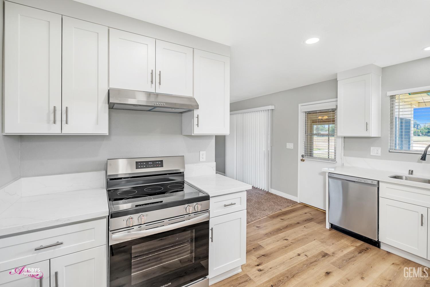 Undisclosed Address Bakersfield, CA 93309 - Photo 16 of 42 a kitchen with granite countertop a stove and a sink