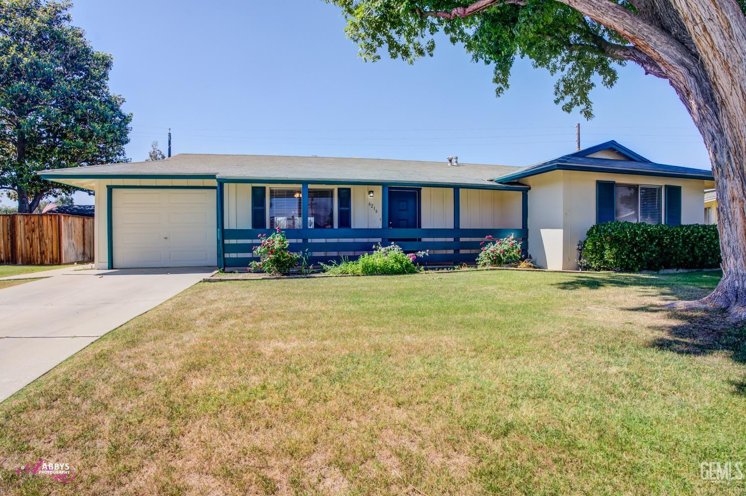 Undisclosed Address Bakersfield, CA 93309 - Photo 3 of 42 a front view of a house with yard and parking