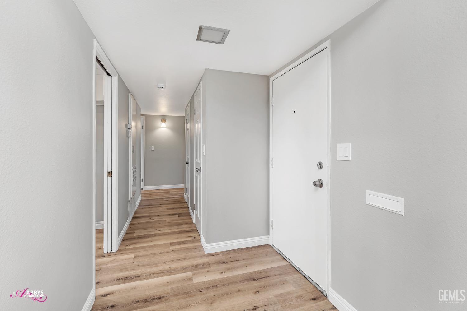 Undisclosed Address Bakersfield, CA 93309 - Photo 7 of 42 a view of a hallway with wooden floor