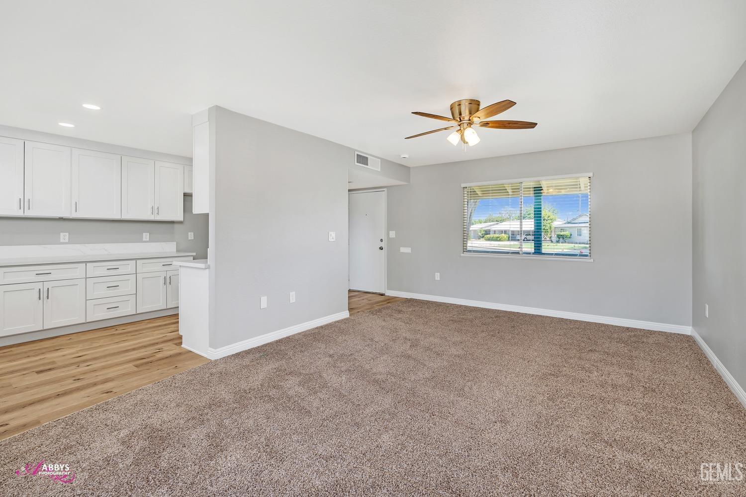 Undisclosed Address Bakersfield, CA 93309 - Photo 9 of 42 an empty room with windows and ceiling fan