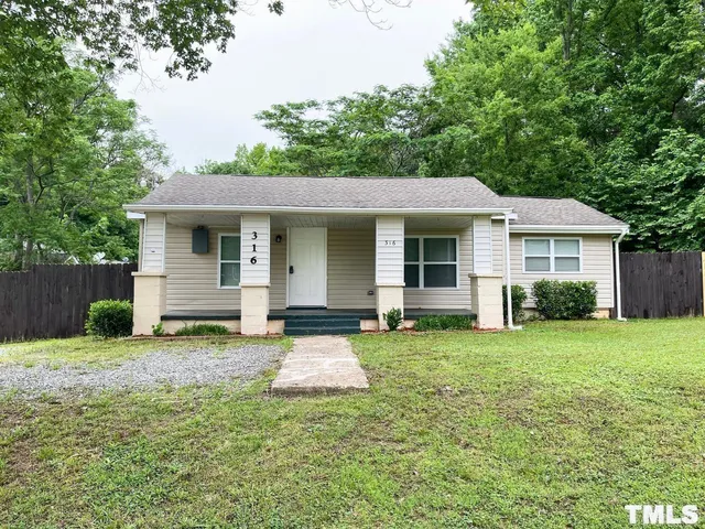 a house that has a big yard in front of it