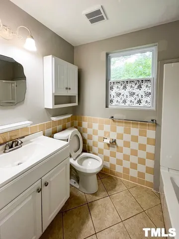 a bathroom with a sink toilet and mirror